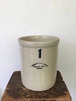 Front view of Medalta pottery crock with clear label and number 1 marking.