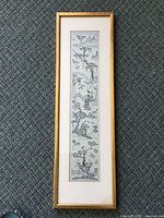 Framed antique Chinese silk embroidery showing vertical scene with figures and landscape.