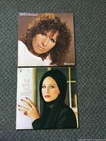 Photo showing the front covers of two Barbara Streisand vinyl albums: 'Memories' featuring a close-up portrait, and 'The Way We Were' featuring a portrait with a dark backdrop.