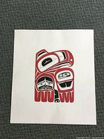Photo of North West Coast style original painting laid flat on carpet showing full artwork with black and red design on white paper.