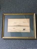Framed charcoal drawing showing multiple boats on calm water with a mat and a gold-tone frame.