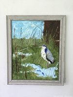 Full view of the framed original bird painting showing the bird standing in a marshy landscape with a blue sky.