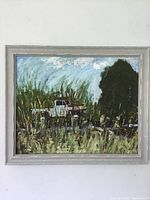 Full view of the original painting on board showing tall grass, truck, large tree, and cloudy sky in a grey painted frame.