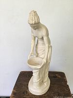 Front view of the statue showing the goddess holding a bowl