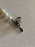 Close-up of the lobster clasp with visible Birks stamp and .925 silver marking on a small attached tag.