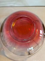 Bottom view of glass bowl showing pink gradient colour and round base