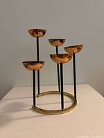 Full view of the copper and brass mid-century modern candelabra showing five cup-shaped candle holders on black rods and brass base.