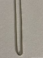 Close-up photo showing chain link detail and box chain pattern.