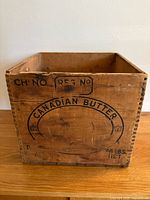 Front and side view of the vintage wooden Canadian Butter box showing the stamped text and wear.