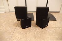 Front view showing both speakers stacked and portions of both stands