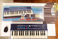 Keyboard, box, adapter, booklets visible