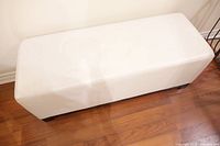 Top view of white faux leather ottoman bench