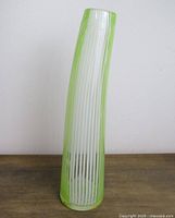 Full view showing curved lime green and white striped vase front