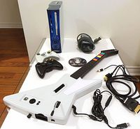 Entire lot overview with console, controllers, guitar, cables, disc