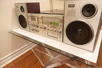 Front angled view of Yorx M2681 main unit flanked by both speakers