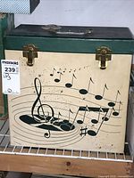 Closed view of the vintage vinyl record carrying case with musical notes design