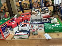 Top view of tabletop display with boxed Christmas items including village houses, light sets and ornaments