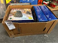 Box showing multiple outdoor light sets including a Holiday Time 150 white mini LED set.