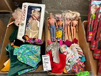 Two boxes with multiple dolls including a Madame Eugene doll in box, loose Barbie dolls, and piles of doll clothing