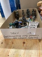 View of the open box showing various metal figurines including soldiers and vehicles