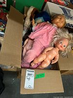 Box containing four dolls, overview of lot