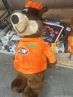 Photo of 36-inch plush bear from A&W wearing bright orange sweater with logo