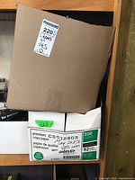 Two large boxes marked containing VHS tapes. One box label notes '2 boxes of VHS' and is taped closed. The second box is a repurposed premium copy paper box marked 'May 2023 VHS tapes unused'.