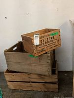 Stacked vintage wooden crates including oyster crate and produce crates