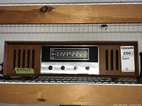 Front view of the vintage Strauss LT-788 tube radio showing wood casing, tuning dial, control knobs and speaker grills