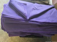 Photo of neatly stacked new purple table napkins