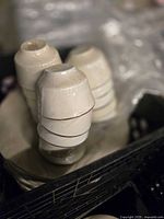 Stacked white ceramic teacups showing smooth, glossy finish