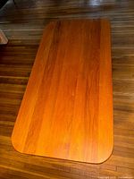 Top view of the rectangular mid-century modern dining table showing the medium brown stained wood surface with rounded corners.