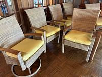 Group of six chairs viewed from front-left showing frames and cushions