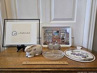 Full lot showing all items arranged on a surface with a ruler for size scale and framed artwork behind them.