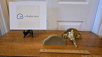 Image of two vintage wall shelves with a measuring ruler and a sign with logo 'a thrifted abode'.