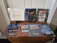 Five books displayed on a table, including Where's Waldo and I Spy series, showing cover details.