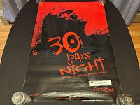 Front side of the 30 Days of Night movie poster showing red and black graphic design and title.