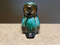 Front view of the Blue Mountain Pottery owl figurine showing green and black drip glaze with stylized owl face and body.