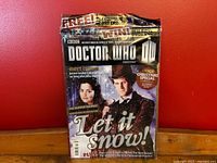 Front cover of factory-sealed Doctor Who Magazine Issue #455 featuring the Eleventh Doctor and Clara Oswald with 'Let it Snow!' text and Christmas special highlight.