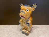 Front view of orange and blue lustreware Bonzo Dog figurine with comic pose and expressive eyes.
