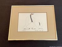 Full view of framed print on dark surface