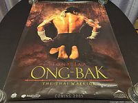 Full view of the original theatrical poster showing Tony Jaa kneeling with back muscles visible. Title and tagline visible with Coming 2005 date.