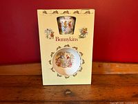 Front of boxed set showing cereal bowl and mug through die-cut windows, decorated with Bunnykins scenes and branding