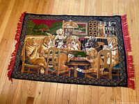 Full view of vintage Dogs Playing Poker woven tapestry showing scene with dogs playing poker at table, barroom background, red fringe edges, and vibrant colors.