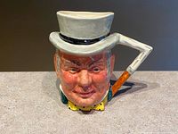 Front view of the hand painted ceramic character mug showing detailed face of Mr. John Bull with top hat and cane-shaped handle.