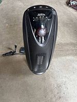 Top front view of the black Sunbeam electric portable heater showing the temperature dial and function icons.