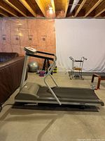 Side view of Trimline 3500 treadmill showing entire machine including belt, supports, and control panel.