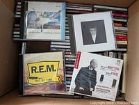 View of some featured CDs on top including Elton John, R.E.M., and Britten classical CD showing diverse genres.