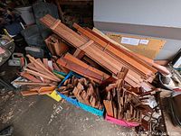 View of a collection of long and short Paduke hardwood pieces arranged in crates and stacked together in a storage area.
