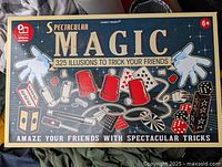 Closed box of the Spectacular Magic set showing branding and images of magic props included in the set.